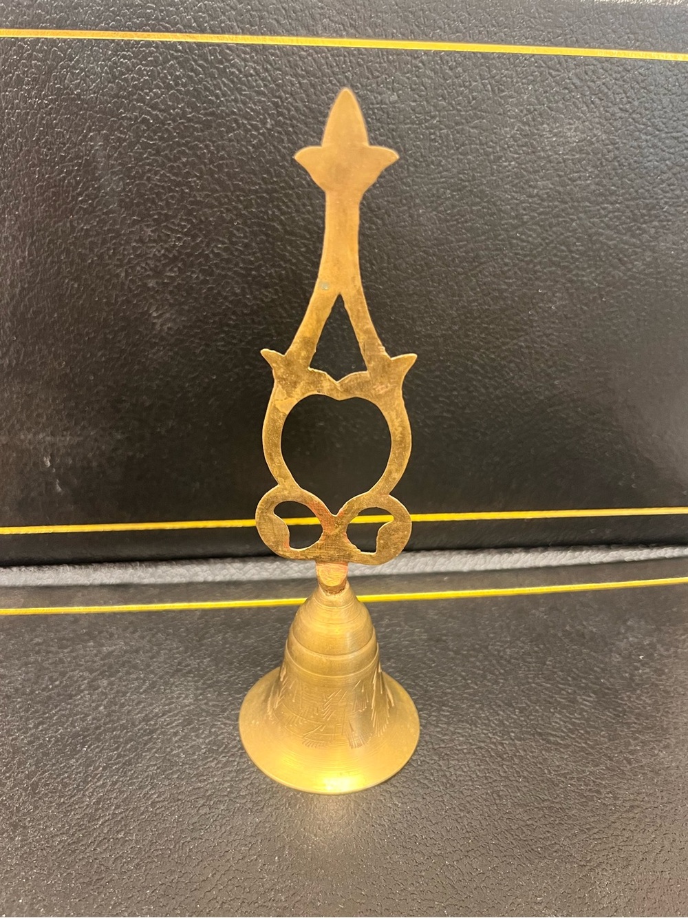 Solid brass hand bell, featuring etching on the bell and a scrolled handle  7 in